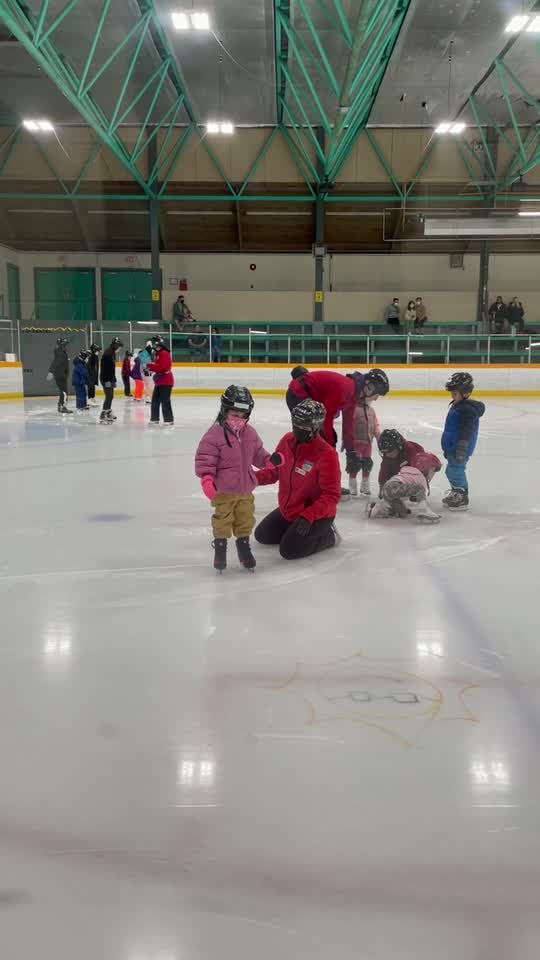 First time skating, with the coach kneeling alongside